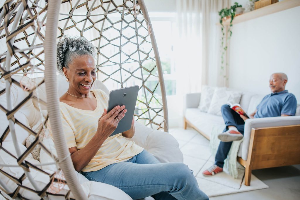 Couple at home using a tablet to prepare for a dermatology appointment